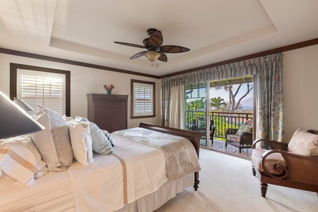 carpeted bedroom with a raised ceiling, access to exterior, and ceiling fan