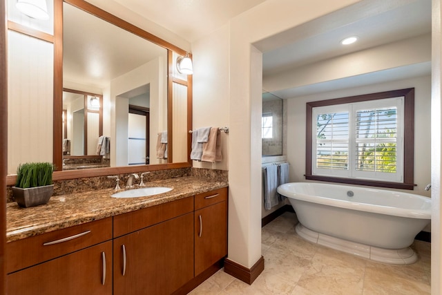 bathroom featuring vanity and a tub