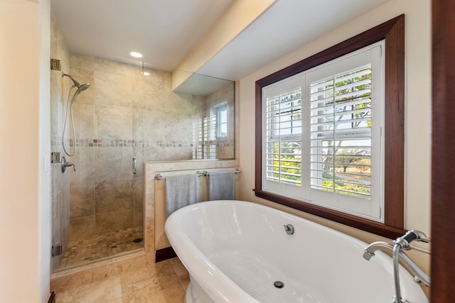 bathroom featuring independent shower and bath