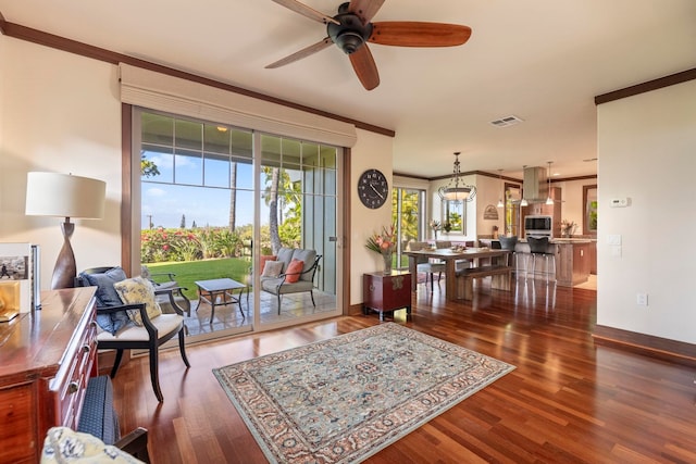 interior space with dark hardwood / wood-style floors, ceiling fan, and crown molding