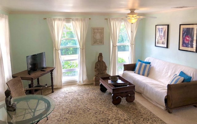 living room featuring ornamental molding and ceiling fan