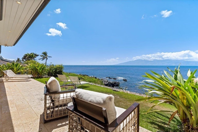 view of patio / terrace featuring a water and mountain view