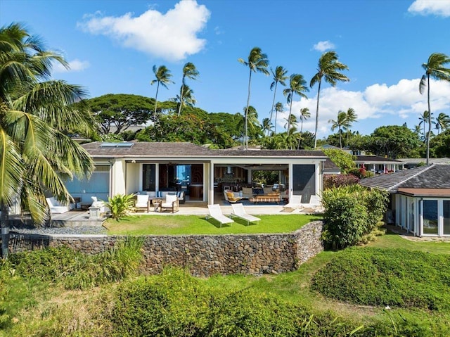 rear view of house featuring a patio area and outdoor lounge area