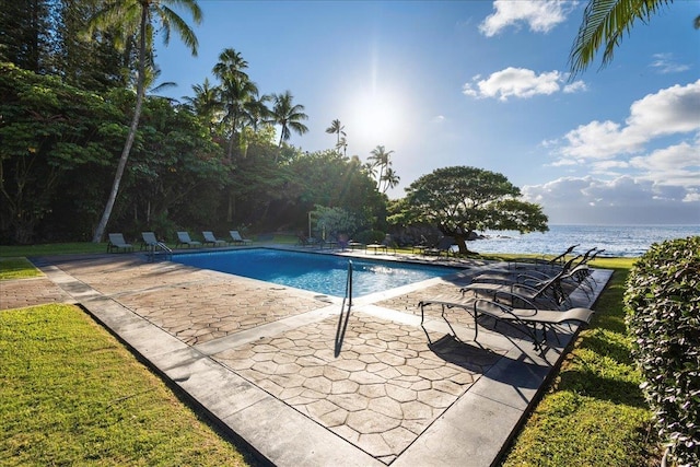view of pool featuring a water view and a patio