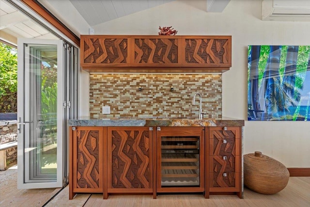 bar featuring backsplash, a wall unit AC, vaulted ceiling, and beverage cooler
