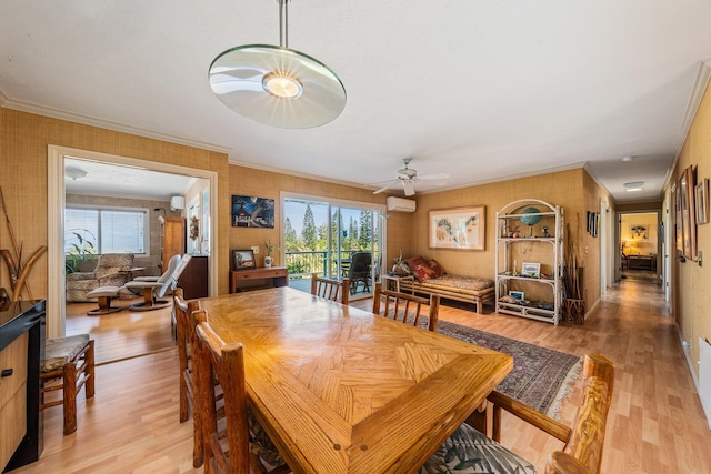 dining space featuring ceiling fan, ornamental molding, light hardwood / wood-style flooring, and an AC wall unit