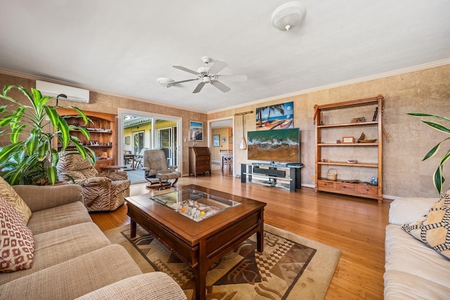 living room featuring ceiling fan, a wall mounted AC, crown molding, and hardwood / wood-style floors