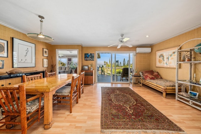 dining space with ceiling fan, a wall mounted AC, ornamental molding, and light hardwood / wood-style flooring