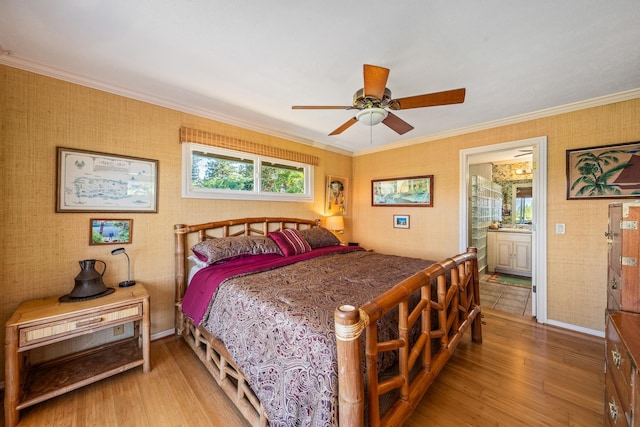 bedroom featuring ceiling fan, crown molding, connected bathroom, and hardwood / wood-style flooring