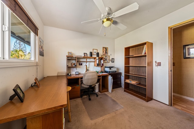 carpeted home office featuring ceiling fan