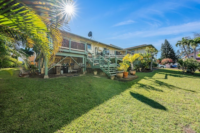 rear view of property with a yard