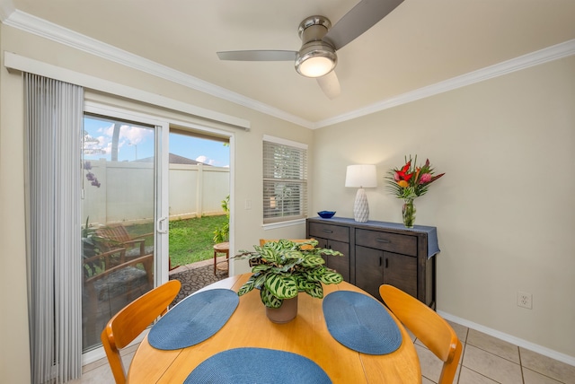 tiled dining area with ceiling fan and crown molding