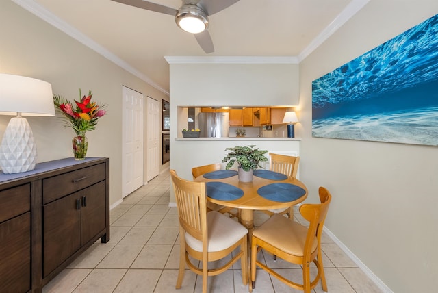 tiled dining space featuring ceiling fan and crown molding