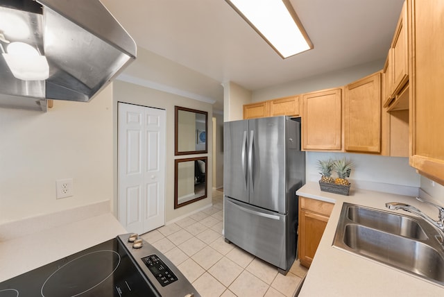 kitchen with light brown cabinets, stainless steel fridge, range, light tile floors, and sink