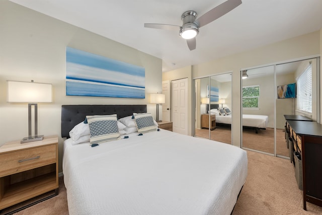 carpeted bedroom with two closets and ceiling fan