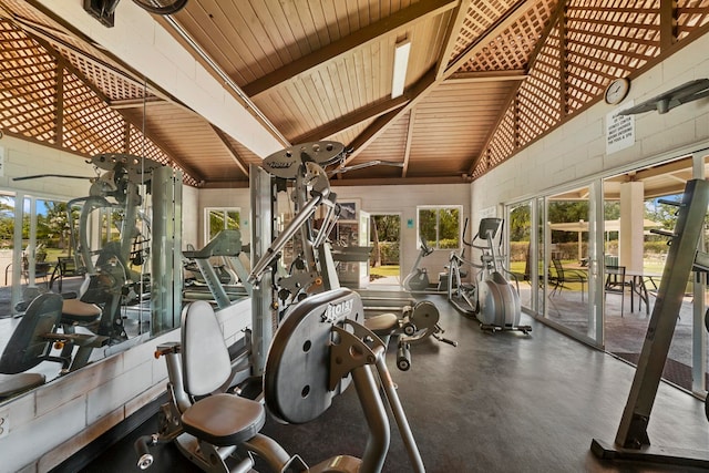 workout area with high vaulted ceiling, concrete floors, and wood ceiling