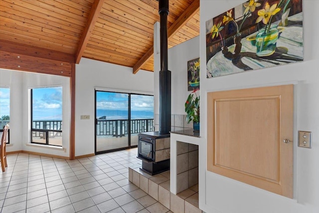 living room featuring light tile patterned floors, wood ceiling, a wood stove, high vaulted ceiling, and beamed ceiling