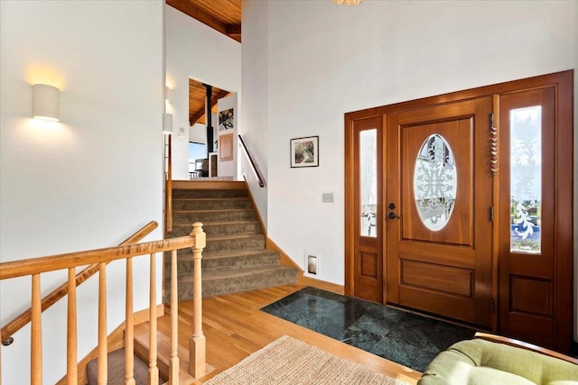 entryway featuring lofted ceiling with beams, wood-type flooring, and wood ceiling