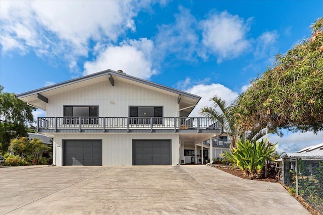 view of front of property featuring a garage and a balcony