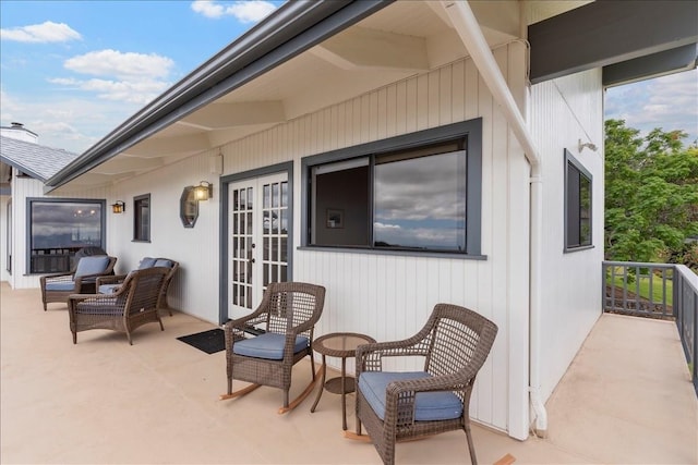 view of patio with french doors and a balcony