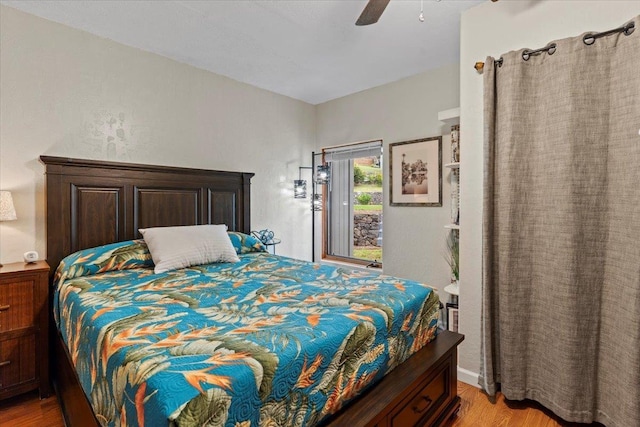 bedroom with ceiling fan and light hardwood / wood-style flooring