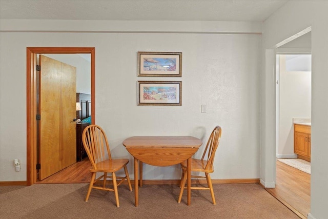 dining space featuring light colored carpet