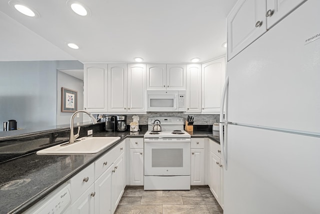 kitchen featuring tasteful backsplash, white appliances, white cabinetry, and a sink