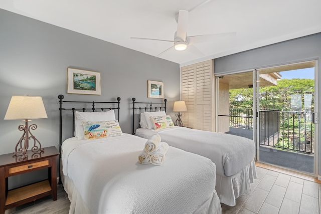 bedroom featuring access to outside, wood finished floors, and a ceiling fan