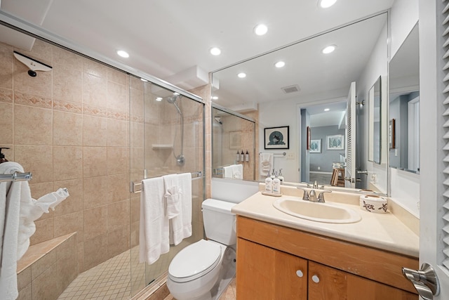 full bathroom featuring visible vents, toilet, vanity, a shower stall, and recessed lighting