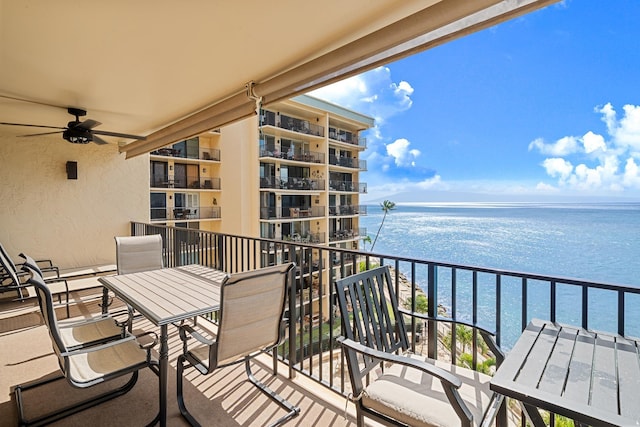 balcony featuring a water view and ceiling fan