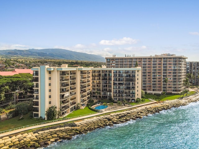 view of building exterior featuring a water and mountain view