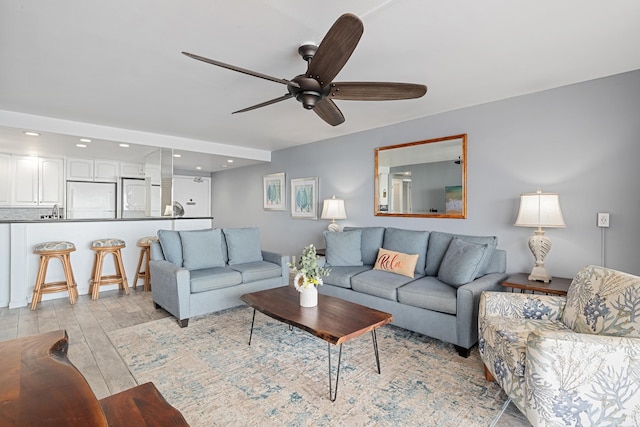 living room with light wood-style floors, recessed lighting, and ceiling fan