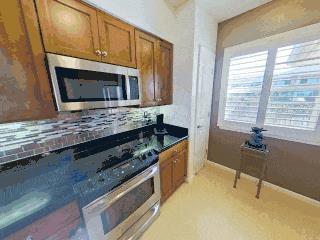 kitchen with appliances with stainless steel finishes and dark stone counters