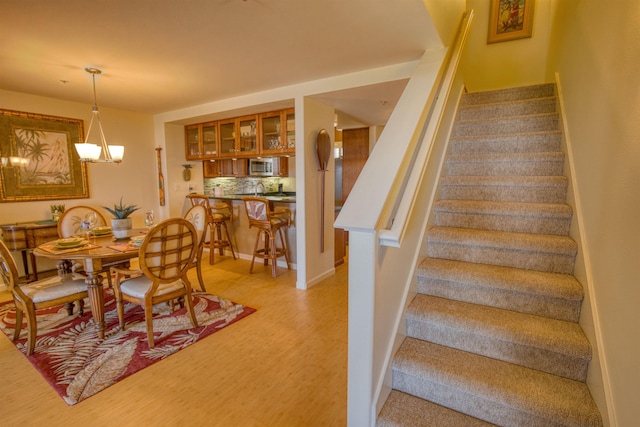 stairs featuring an inviting chandelier