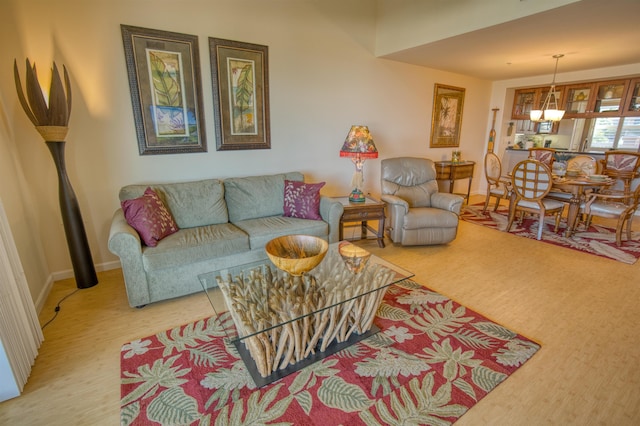 living room with a notable chandelier and light wood-type flooring