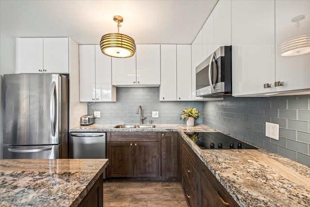 2387 S Kihei Rd Unit C108, Kihei, HI 96753 - kitchen featuring appliances with stainless steel finishes, a sink, dark brown cabinets, light stone counters, and tasteful backsplash