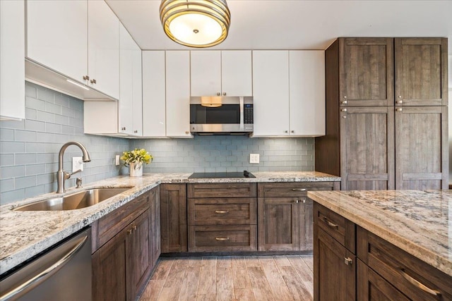 2387 S Kihei Rd Unit C108, Kihei, HI 96753 - kitchen with stainless steel appliances, a sink, white cabinetry, and tasteful backsplash