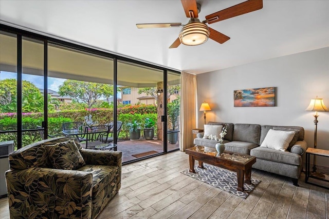 2387 S Kihei Rd Unit C108, Kihei, HI 96753 - living room featuring expansive windows, wood finished floors, and a ceiling fan