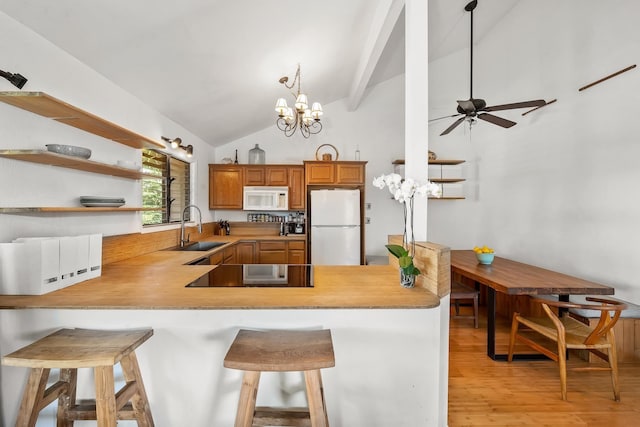15 Kulanihakoi St Unit 3E, Kihei, HI 96753 - kitchen featuring a sink, a peninsula, white appliances, and lofted ceiling with beams