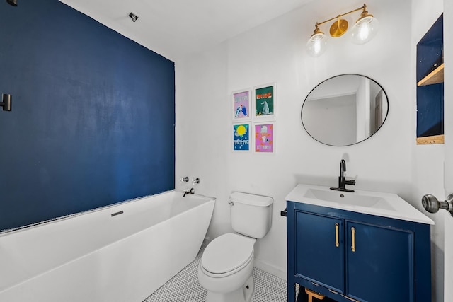 15 Kulanihakoi St Unit 3E, Kihei, HI 96753 - bathroom featuring toilet, baseboards, tile patterned floors, vanity, and a freestanding bath