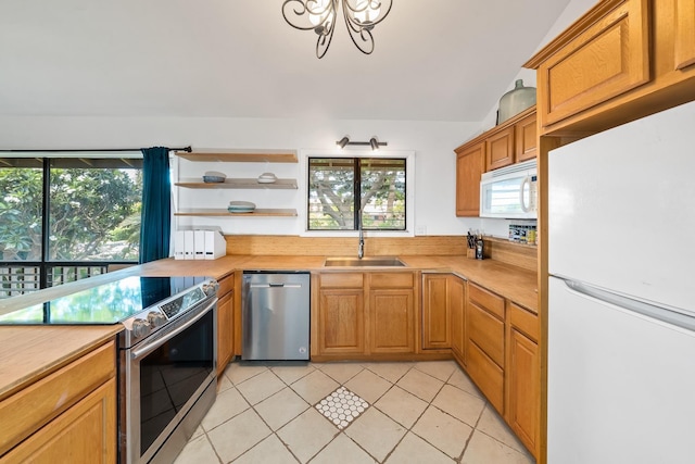 15 Kulanihakoi St Unit 3E, Kihei, HI 96753 - kitchen with a wealth of natural light, light countertops, stainless steel appliances, and light tile patterned flooring