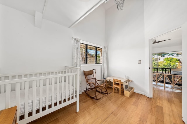 15 Kulanihakoi St Unit 3E, Kihei, HI 96753 - bedroom featuring baseboards, multiple windows, a towering ceiling, and wood finished floors