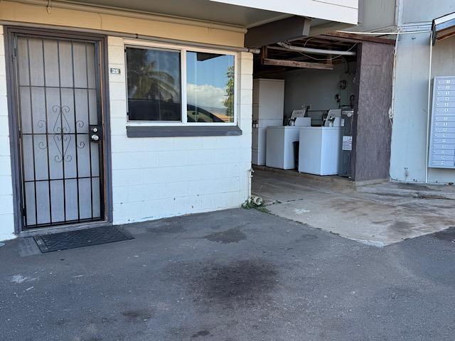 471 Liholiho St Unit 25, Wailuku, HI 96793 - entrance to property featuring washing machine and dryer and concrete block siding
