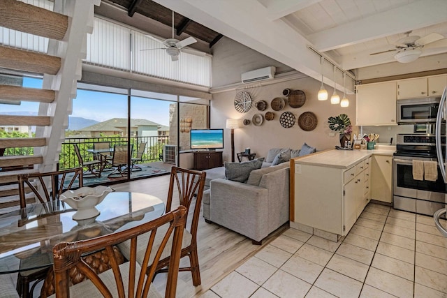 kitchen featuring appliances with stainless steel finishes, a wall mounted AC, ceiling fan, light tile patterned floors, and beamed ceiling