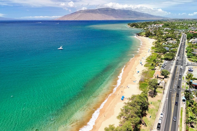 aerial view featuring a beach view and a water and mountain view