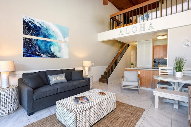 living room with high vaulted ceiling