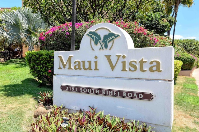 community / neighborhood sign featuring a lawn