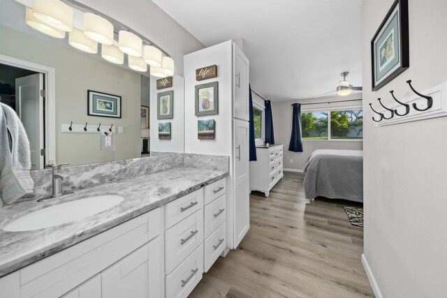 155 Aliilani Pl, Kihei, HI 96753 - bathroom with wood finished floors, ceiling fan, ensuite bathroom, vanity, and baseboards
