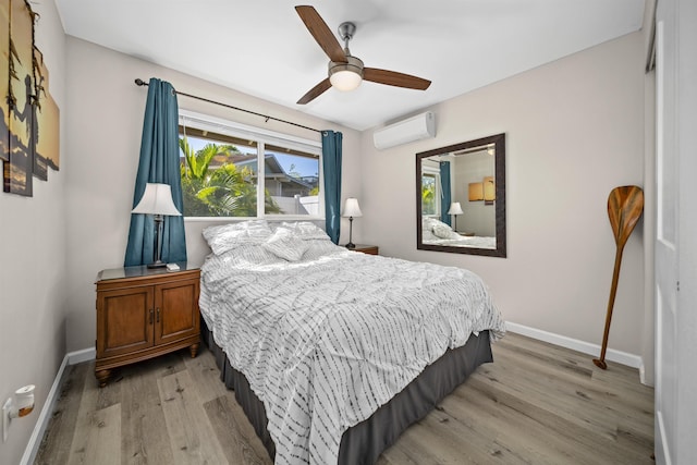155 Aliilani Pl, Kihei, HI 96753 - bedroom featuring a wall mounted air conditioner, light wood-style floors, baseboards, and ceiling fan
