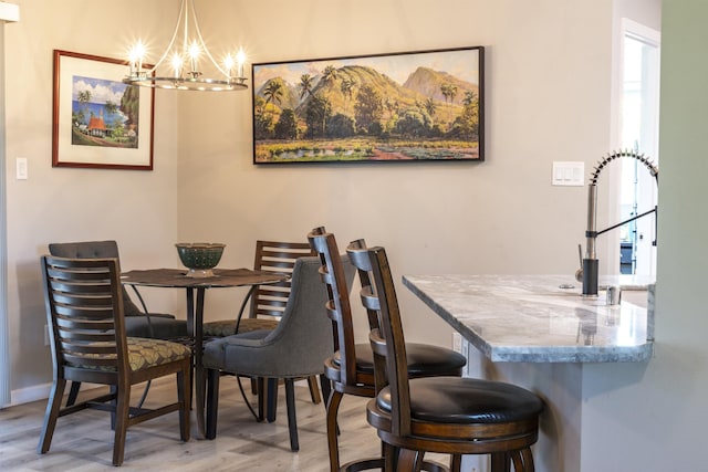 155 Aliilani Pl, Kihei, HI 96753 - dining room with a chandelier, wood finished floors, and baseboards